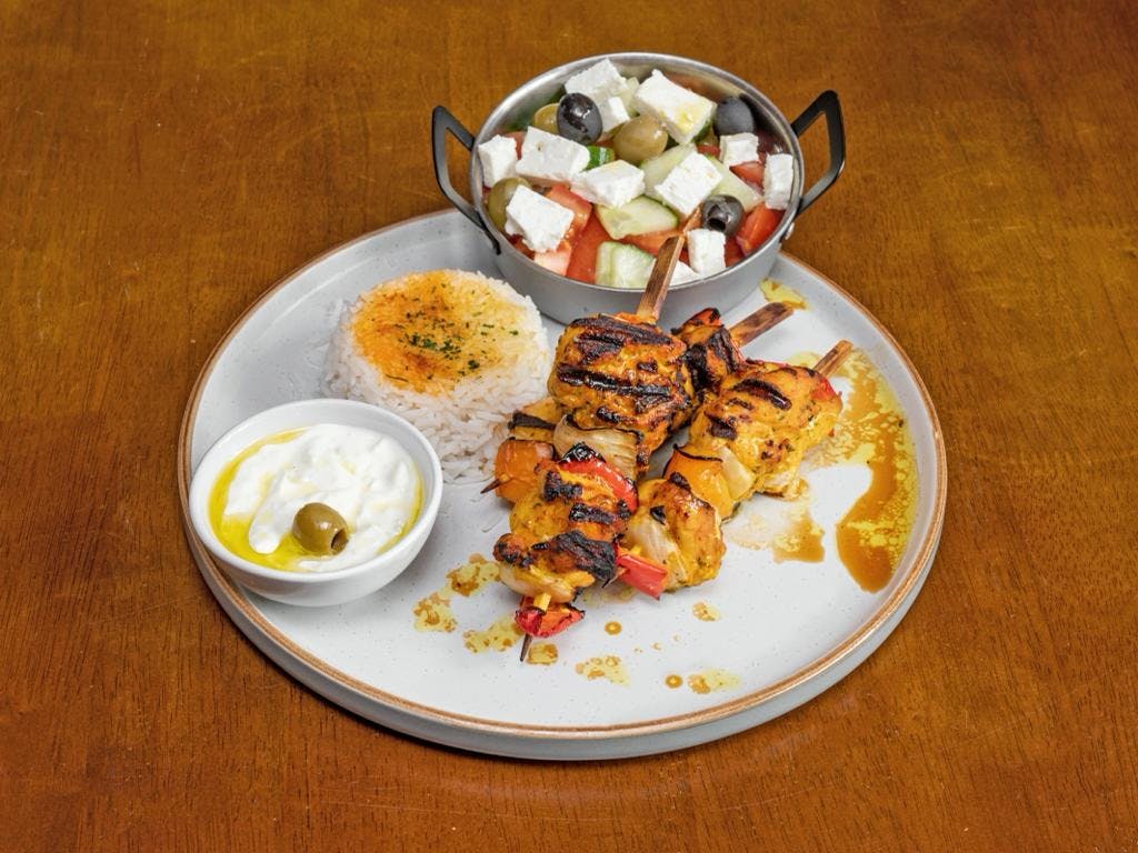 Chicken skewers plated on a table